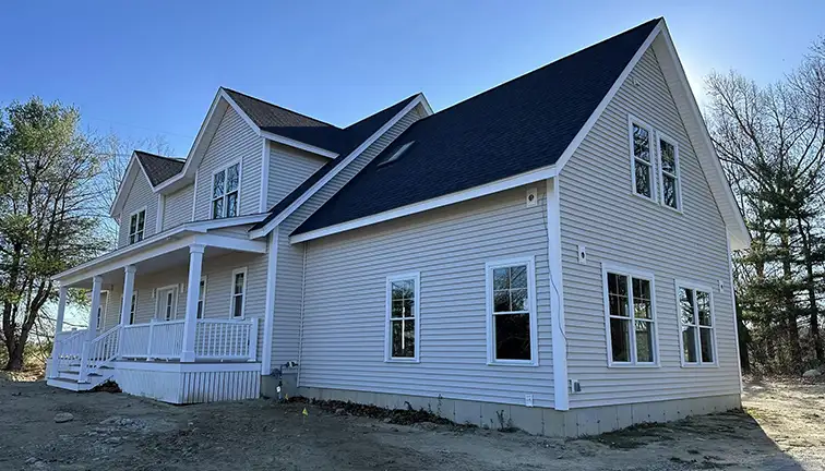 Professional team performing vinyl siding cleaning and maintenance on a home in Edmonton.